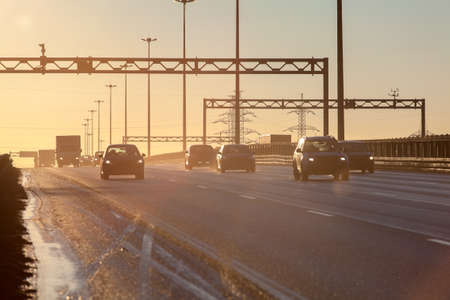 Highway road with cars silhouettes during sunsetの写真素材