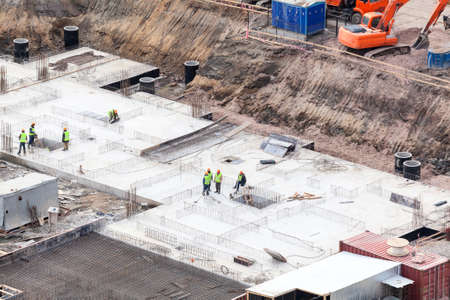 Construction site with workers making foundation