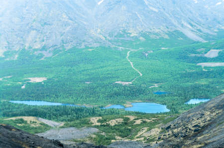 Mountain valley with lakes and coniferous forests, aerial viewの写真素材