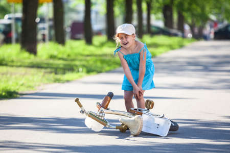 Pretty Caucasian girl with pain in knee when falled downの写真素材