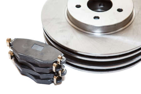 Two brake disks and pads isolated on white backgroundの写真素材