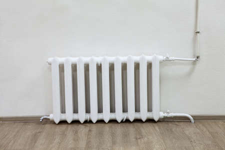 White iron radiator central heating on wall in roomの写真素材