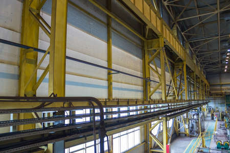 Metallic columns of production workshop with industrial communicationsの写真素材