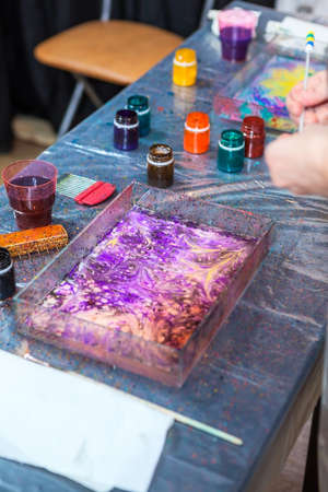 Stained with paints table with marbling basinの写真素材