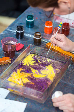 Maling beautiful marbling pattern with inks and stickの写真素材