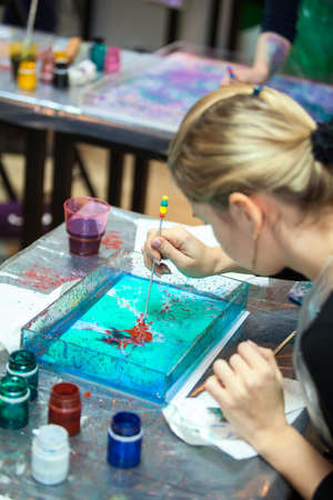 Painter making ebru drawing in water surfaceの写真素材