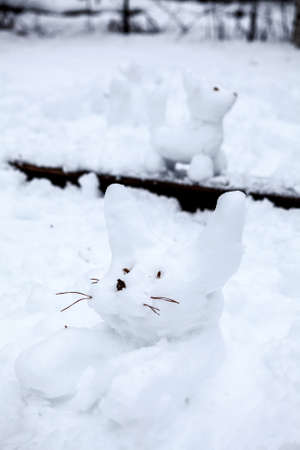 Rabbit and dog snowmen at winter timeの写真素材