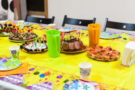 Holiday table with snacks, children birthday or party celebrationの写真素材