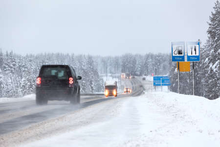 Vehicles driving on the Kola highway in winter season. The Kola is a federal road from St. Petersburg to Murmanskの写真素材
