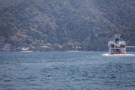 MIYAJIMAGUCHI, JAPAN - CIRCA APR, 2013: Ferry of JR company comes to the island of Miyajima (Itsukushima). View from the city Miyajimaguchi. The Hiroshima gulf, Japan.のeditorial素材