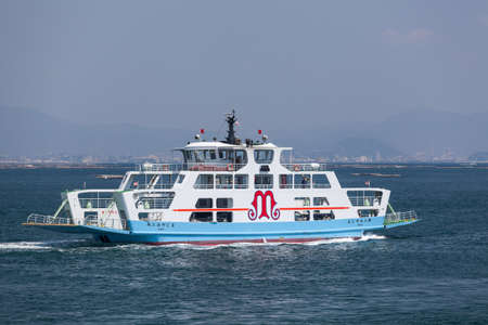 MIYAJIMAGUCHI, JAPAN - CIRCA APR, 2013: The ferry of Matsudai Kisen company comes to Miyajimaguchi town pier. Two ferry-boats for Itsukushima island travel. The Hiroshima gulf, Japan.のeditorial素材