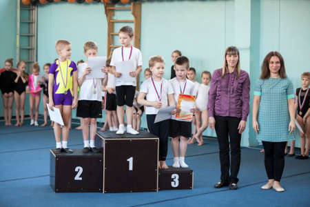 ST. PETERSBURG, RUSSIA - CIRCA APR, 2014: Winners of aerobics, boys are on the podium with the medals and certificates. Russian children competitionsのeditorial素材