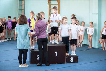 ST. PETERSBURG, RUSSIA - CIRCA APR, 2014: Winners of aerobics, boys are on the podium with the medals and certificates. Russian children competitionsのeditorial素材