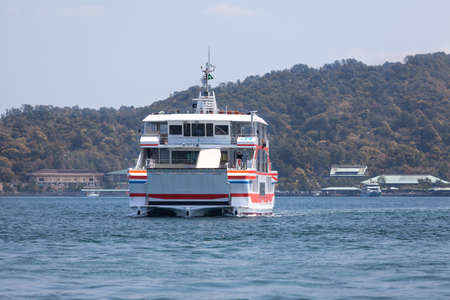 MIYAJIMAGUCHI, JAPAN - CIRCA APR, 2013: Ferry-boat of JR company comes from the island of Miyajima (Itsukushima). View from the city Miyajimaguchi. The Hiroshima gulf, Japan.のeditorial素材