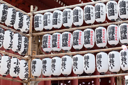 TOKYO, JAPAN - CIRCA APRIL, 2012: Many white and black paper lanters with Japanese characters are in Sensoji shrine area. The Senso-ji is an ancient Buddhist temple located in Asakusa districtのeditorial素材