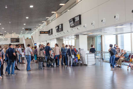 ST. PETERSBURG, RUSSIA - CIRCA JUL, 2015: Passengers stand in queue at departure lounge for aircraft boarding. Interior of new building of Pulkovo International airportのeditorial素材