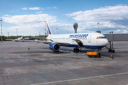 ST. PETERSBURG, RUSSIA - CIRCA JUL, 2015: Aircraft on Transaero company is under boarding and loading. Runway of Pulkovo International airport (LED)のeditorial素材