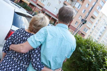 Senior couple making selfie with phone on the stick, rear viewの写真素材