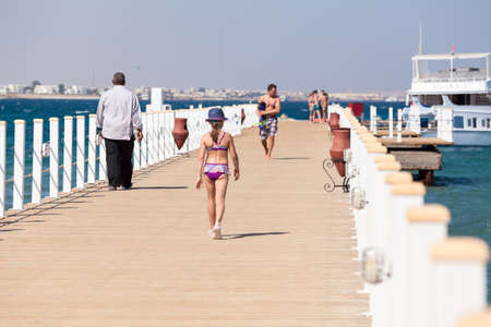 Pier for ships mooring is on the Red Sea coast line. People walk on the wooden planks for diving and snorkelingのeditorial素材