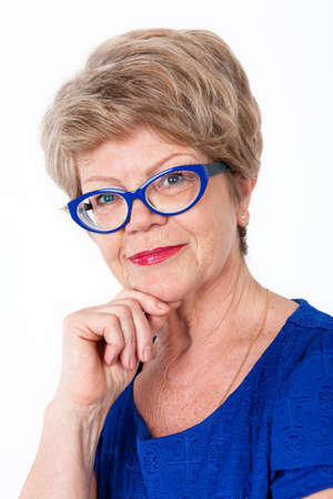 Facial portrait of happy Caucasian woman in blue dress and eyeglasses, white backgroundの写真素材