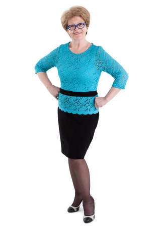 Satisfied elderly Caucasian woman in black skirt and blue blouse in full length, isolated on white backgroundの写真素材