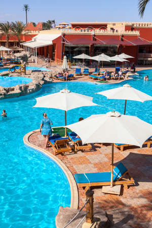 HURGHADA, EGYPT - CIRCA NOV, 2015: Poolside with sun parasols is in the Egyptian hotel. The Alf Leila Wa Leila spa (1001 Nights) is one of the Pickalbatrosのeditorial素材