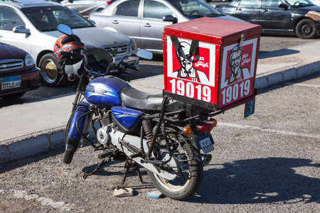 HURGHADA, EGYPT - CIRCA NOV, 2015: The KFC delivery bike is on the parking lot. Kentucky Fried Chicken (KFC) is a fast food restaurant chain, also is in Egyptのeditorial素材