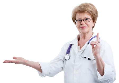 Woman doctor showing with outstretched hand towards, isolated on a white backgroundの写真素材