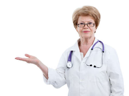 Mature female doctor with outstretched hand towards, isolated on a white backgroundの写真素材