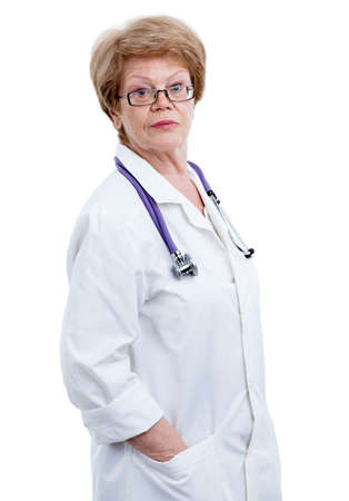 Caucasian an elder woman a doctor looking at the camera, hands in pockets, isolated on white backgroundの写真素材