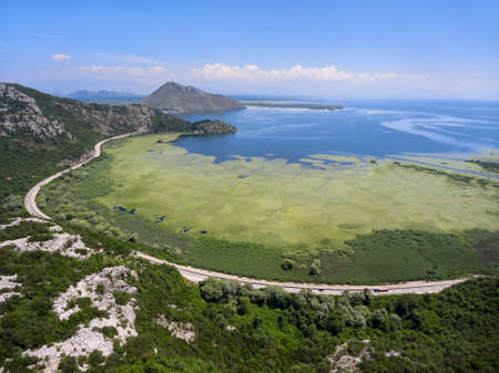 Aerial view of the Skadar lake with highway around. Skadarsko jezero is a national park in Montenegroの写真素材