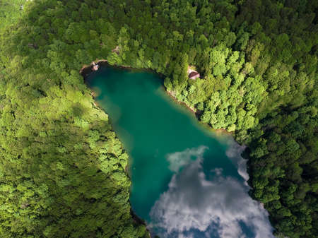 The Biograd lake. Calm reflecting water is in lush green forest of Bjelasica mountains, Kolasin, Montenegroの写真素材