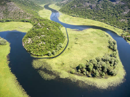 Aerial view Rjieka Crnojevica watercourse. Beauty nature of river in mountains. Part of Skadar lake and national park in Montenegroの写真素材