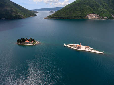Gospa od Skrpjela and Sveti Dordje artificial islands are in Adriatic sea in Bay of Kotor (Boka Kotorska). Montenegro. Aerial viewの写真素材