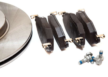 New brake pads and two steel ventilated brake disks isolated on white backgroundの写真素材