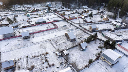 Russian summer village covered with snow. Empty timber houses and courtyards. Winter is in Karelia, Russiaの写真素材