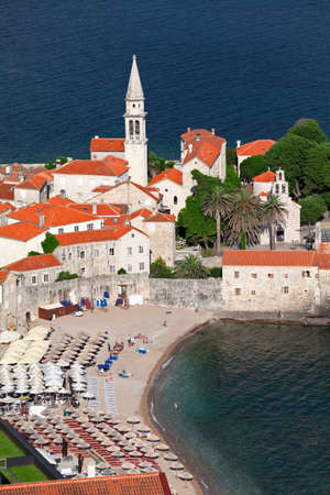 The old walled town of Budva is on peninsula in Adriatic sea. City beach the Ricardova Glava. Top view. Montenegro, Europeの写真素材