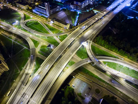 ST. PETERSBURG, RUSSIA, CIRCA MAY, 2016: Night view at junctions of city beltway. Color illumination is on roads. Vehicles drive on highwayのeditorial素材