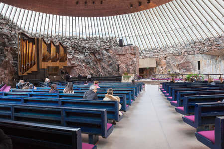 HELSINKI, FINLAND - CIRCA SEP, 2016: Hall with natural lighting, benches and the stage. The Finnish church Temppeliaukio. The temple is carved into the rock.のeditorial素材