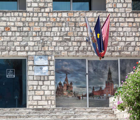 BUDVA, MONTENEGRO - CIRCA JUN, 2016: Information plates and flags of honorary Consulate of the Russian Federation are on the facade of the Avala Resort & Villas in city of Budva.のeditorial素材