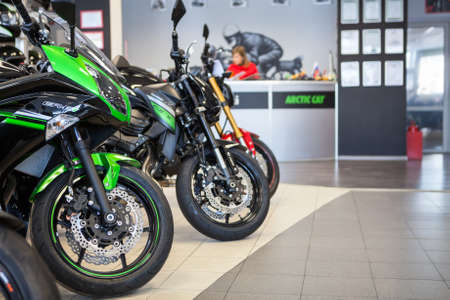 ST. PETERSBURG, RUSSIA - CIRCA FEB, 2017: Motorcycle dealer showroom with bikes and reception desk with salesmen. Official dealership of Kawasaki and Ducati brands is in cityのeditorial素材