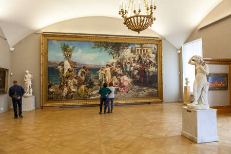 ST. PETERSBURG, RUSSIA - CIRCA APR, 2017: Visitors looking at the picture "Frina at the Poseidon festival" by Semiradsky G.I. Interior of Russian State Museum in Mikhailovsky Palaceのeditorial素材
