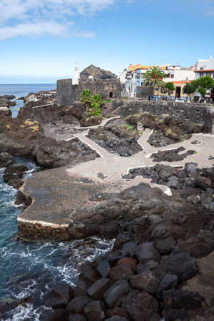 GARACHICO, TENERIFE, SPAIN-CIRCA JAN, 2016: Volcanic formation coastline without sandy beaches is in Garachico. People rest and walk on embankment. The Garachico is an ancient town on the northのeditorial素材