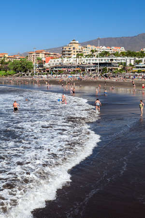 COSTA ADEJE, TENERIFE, SPAIN-CIRCA JAN, 2016: Ocean bay of Playa Fanabe with swimming and sunbathing people. Playa Fanabe is the most visited city beach on the south of Canarのeditorial素材