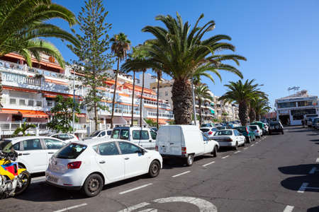 LOS CRISTIANOS, TENERIFE, SPAIN - CIRCA JAN, 2016: Parallel parking areas are in street of resort city. Full parking lots are in city at summer seasonのeditorial素材