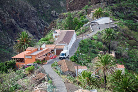 MASCA, TENERIFE, SPAIN - CIRCA JAN, 2016: Souvenir shop and cafe are on street of Masca village. Visitors walk to paved road. Masca is a small mountain village with popular hiking routeのeditorial素材