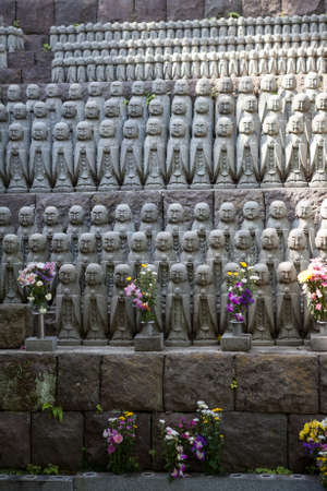 KAMAKURA, JAPAN â CIRCA APR, 2013: Thousands of little Jizo stone statues stand in long rows near Jizo-do Hall of Hasedera. The statues are there to comfort the souls of unborn childrenのeditorial素材