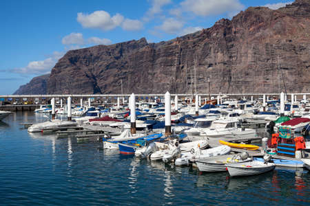 LOS GIGANTES, TENERIFE, SPAIN - CIRCA JAN, 2016: Motorboats and cruise yachts are in port of Los Gigantes town. Los Gigantes is a resort town in the Santiago del Teide municipality on the west coast.のeditorial素材