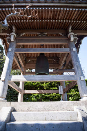 KAMAKURA, JAPAN â CIRCA APR, 2013: Wooden bell tower with traditional roof is in inner courtyard of Hasedera Shrine. Temple is near the village of Hase in the Nara regionのeditorial素材