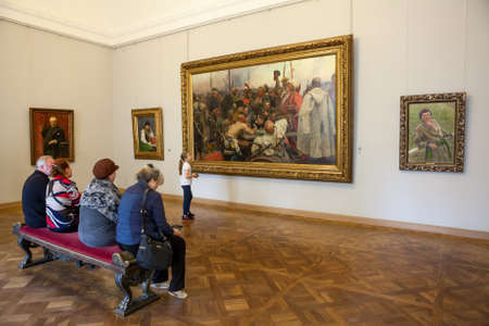 ST. PETERSBURG, RUSSIA - CIRCA APR, 2017: People are near picture "Reply of the Zaporozhian Cossacks to Sultan Mehmed IV of the Ottoman Empire" by Ilya Repin. Russian Museum, the Mikhailovsky Palaceのeditorial素材